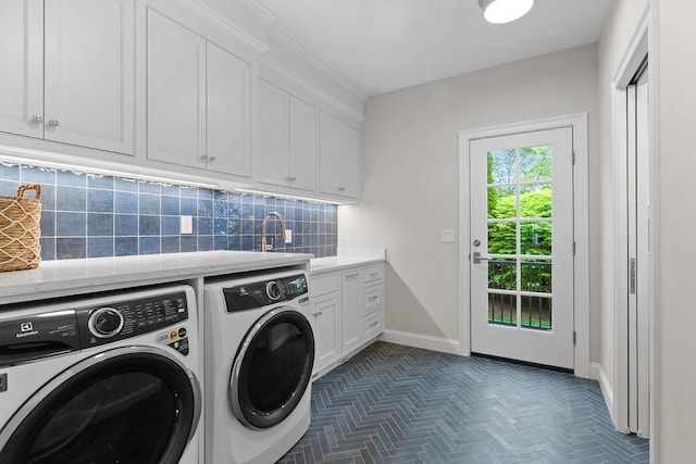 64 Pershing Ln, Orleans, MA 02653 - laundry area featuring separate washer and dryer, baseboards, and cabinet space