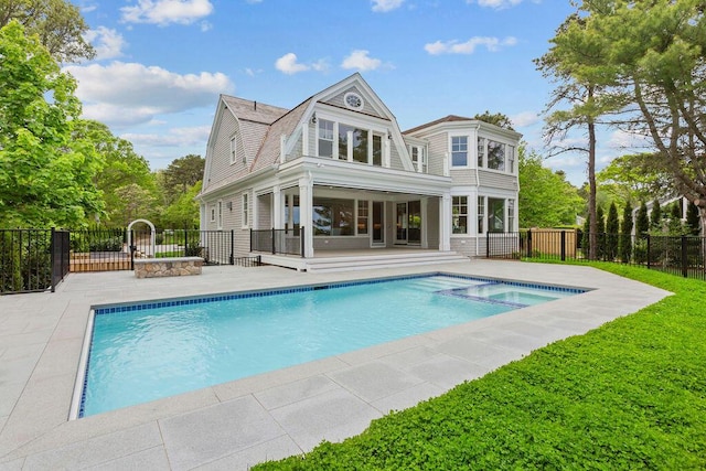 64 Pershing Ln, Orleans, MA 02653 - rear view of property featuring a patio area, a pool with connected hot tub, and a gambrel roof
