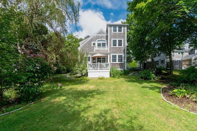 back of house with a lawn