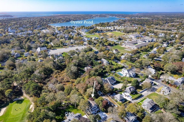 aerial view with a forest view, a water view, and a residential view