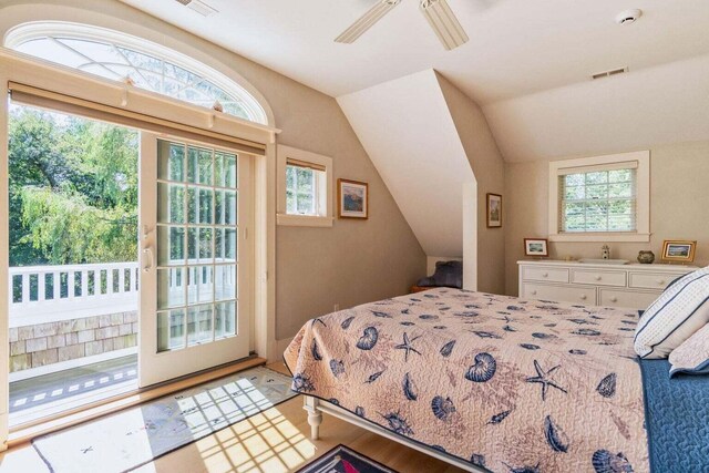 bedroom featuring access to exterior, lofted ceiling, visible vents, and a ceiling fan