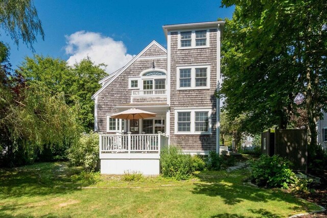 rear view of property featuring a lawn