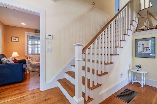 stairs with hardwood / wood-style flooring