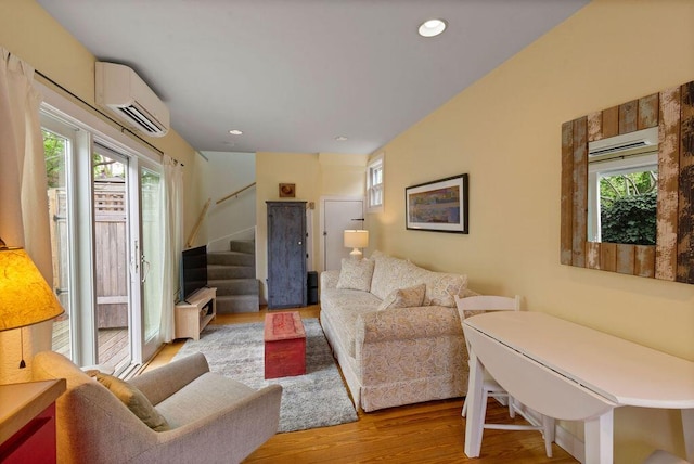 48 Pleasant St Unit U3, Provincetown, MA 02657 - living area featuring a wall mounted air conditioner, light wood finished floors, stairway, healthy amount of natural light, and recessed lighting
