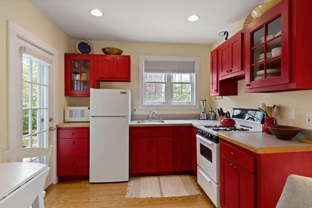 48 Pleasant St Unit U3, Provincetown, MA 02657 - kitchen with white appliances, plenty of natural light, light wood-type flooring, reddish brown cabinets, and recessed lighting
