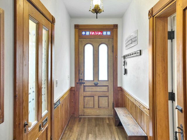 interior space featuring wood-type flooring and wood walls