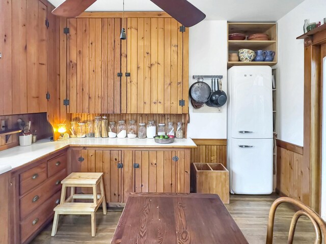 kitchen featuring light hardwood / wood-style flooring and wood walls