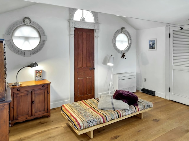 living area featuring lofted ceiling and light wood-type flooring