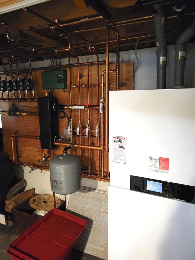 utility room featuring water heater