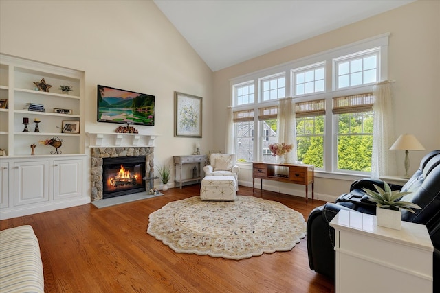 101 Pheasant Hill Cir, Cotuit, MA 02635 - living area featuring a stone fireplace, high vaulted ceiling, and wood finished floors