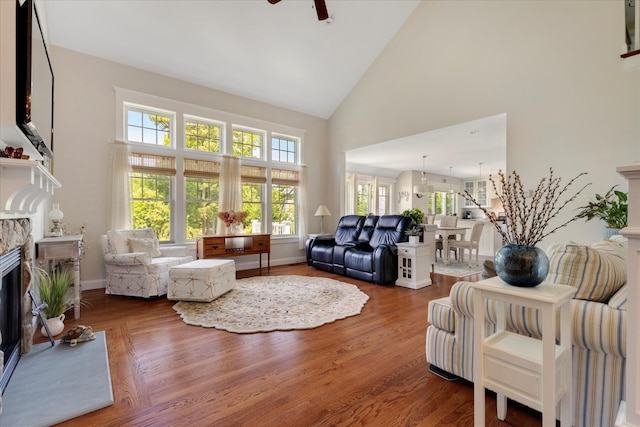 101 Pheasant Hill Cir, Cotuit, MA 02635 - living room featuring high vaulted ceiling, a fireplace, plenty of natural light, and wood finished floors