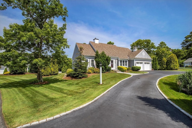 101 Pheasant Hill Cir, Cotuit, MA 02635 - view of front of house featuring a garage, driveway, a front yard, and a chimney