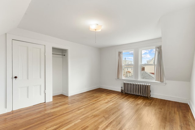 104R Homes Ave, Boston, MA 02123 - unfurnished bedroom with radiator, light wood-type flooring, baseboards, and a closet