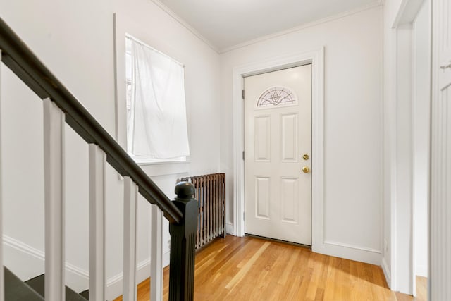 104R Homes Ave, Boston, MA 02123 - entryway with radiator heating unit, light wood finished floors, crown molding, baseboards, and stairs