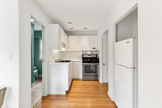 104R Homes Ave, Boston, MA 02123 - kitchen featuring freestanding refrigerator, gas range, a sink, under cabinet range hood, and light wood-type flooring