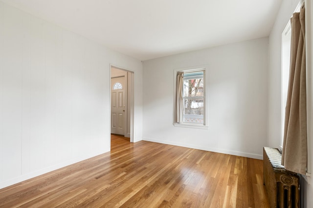 104R Homes Ave, Boston, MA 02123 - spare room with light wood-style floors, baseboards, and radiator heating unit