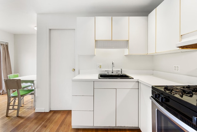 104R Homes Ave, Boston, MA 02123 - kitchen featuring a sink, white cabinetry, light countertops, stainless steel range with gas cooktop, and light wood finished floors