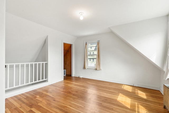 104R Homes Ave, Boston, MA 02123 - bonus room featuring wood finished floors, baseboards, lofted ceiling, and radiator