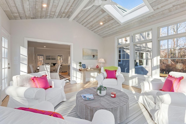 sunroom / solarium featuring lofted ceiling with skylight