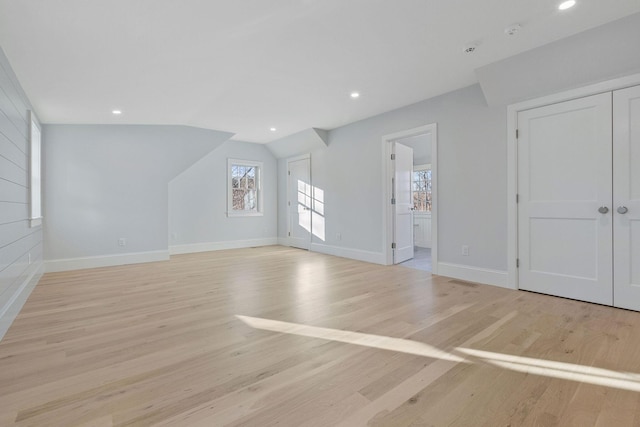 unfurnished living room featuring light hardwood / wood-style flooring and vaulted ceiling