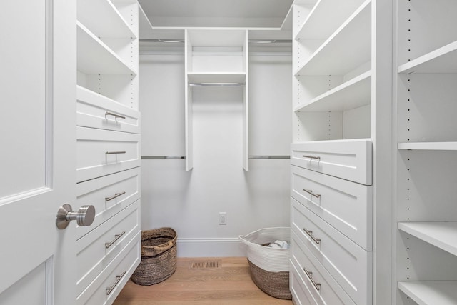 walk in closet featuring hardwood / wood-style floors