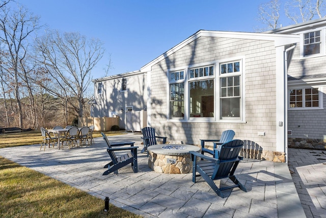 back of house with a fire pit and a patio area