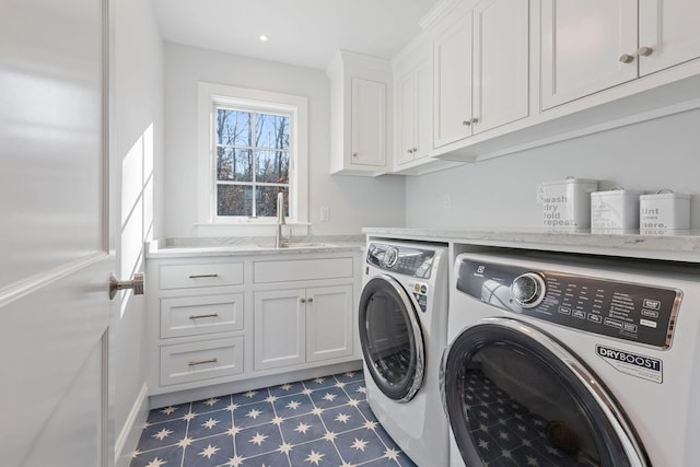 laundry room featuring washer and dryer, cabinets, and sink