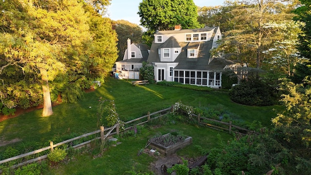 250 Scraggy Neck Rd, Cataumet, MA 02534 - back of house featuring a vegetable garden, a chimney, and a sunroom