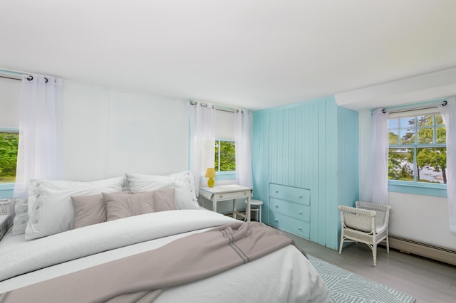 250 Scraggy Neck Rd, Cataumet, MA 02534 - bedroom with multiple windows and wood finished floors