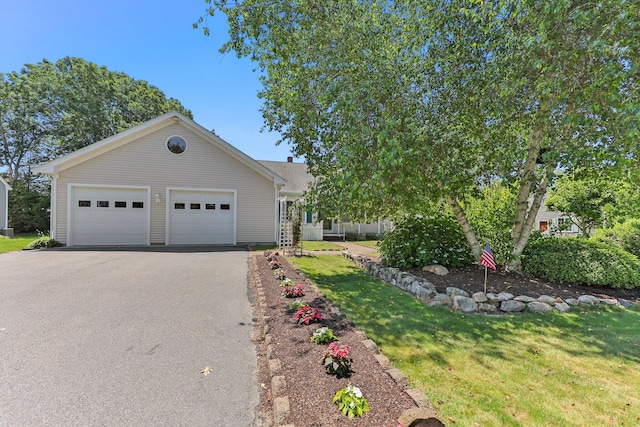 view of front of property featuring a garage and a front lawn