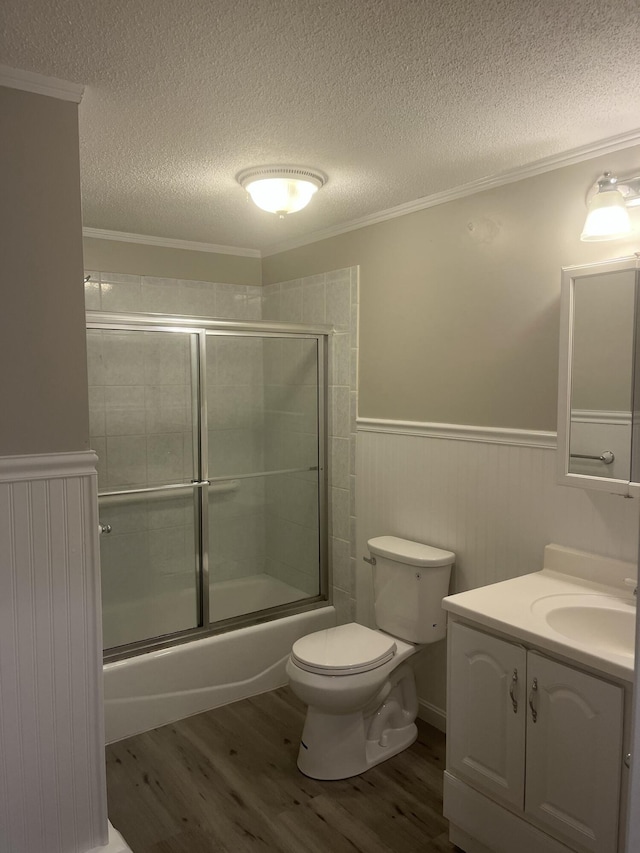 12 Pine Ter, East Sandwich, MA 02537 - bathroom with wood finished floors, wainscoting, a textured ceiling, vanity, and enclosed tub / shower combo