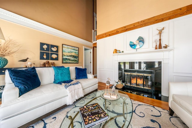 11 Allyn Ln, Barnstable, MA 02630 - living area featuring a glass covered fireplace, a towering ceiling, and wood finished floors