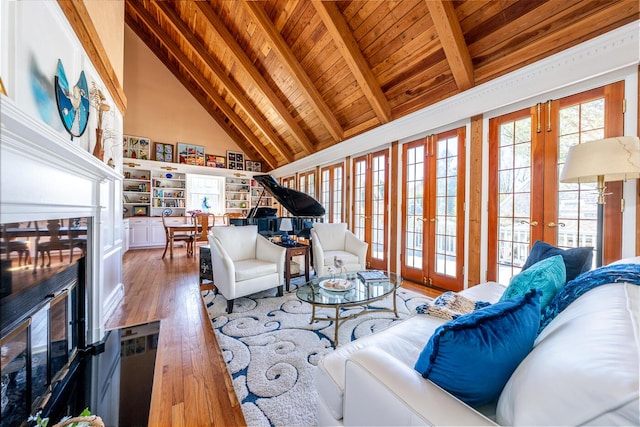 11 Allyn Ln, Barnstable, MA 02630 - living room featuring high vaulted ceiling, a fireplace, wood ceiling, wood finished floors, and french doors