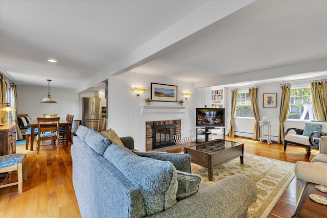 194 John Joseph Rd, Harwich, MA 02645 - living room with a fireplace, wood finished floors, a baseboard heating unit, and recessed lighting