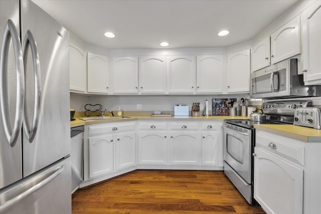 194 John Joseph Rd, Harwich, MA 02645 - kitchen with stainless steel appliances, light countertops, white cabinets, dark wood-style flooring, and recessed lighting