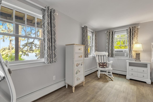 194 John Joseph Rd, Harwich, MA 02645 - living area featuring a baseboard heating unit, wood finished floors, cooling unit, and a water view