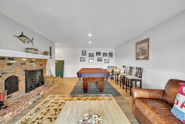 194 John Joseph Rd, Harwich, MA 02645 - living room featuring wood finished floors, pool table, a brick fireplace, wainscoting, and recessed lighting