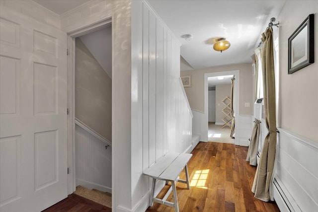 194 John Joseph Rd, Harwich, MA 02645 - hallway with a baseboard heating unit, dark wood-type flooring, wainscoting, and stairs