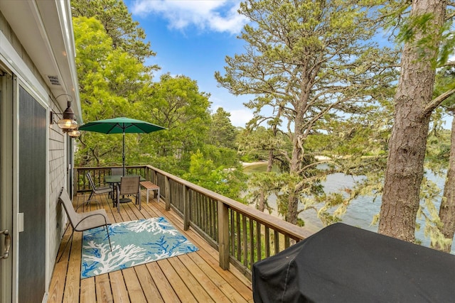 194 John Joseph Rd, Harwich, MA 02645 - deck with outdoor dining area, view of wooded area, and area for grilling