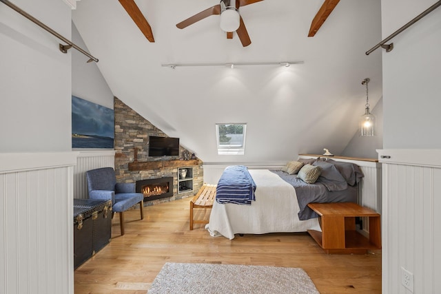 10 Seashore Park Dr Unit Ugg, Provincetown, MA 02657 - bedroom featuring wood finished floors, a wainscoted wall, a stone fireplace, and ceiling fan