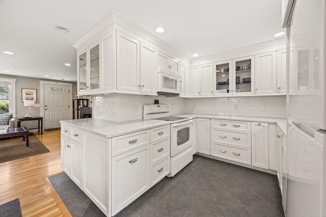 10 Seashore Park Dr Unit Ugg, Provincetown, MA 02657 - kitchen featuring white appliances, recessed lighting, white cabinetry, backsplash, and light stone countertops
