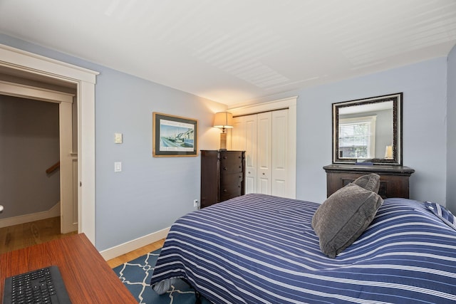 10 Seashore Park Dr Unit Ugg, Provincetown, MA 02657 - bedroom featuring a closet, light wood-type flooring, and baseboards