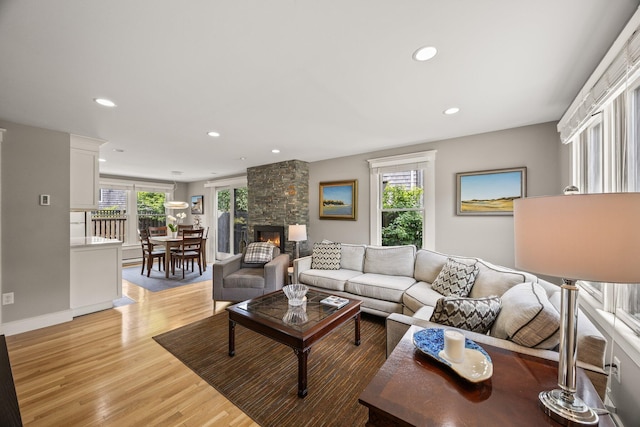 10 Seashore Park Dr Unit Ugg, Provincetown, MA 02657 - living area featuring light wood finished floors, recessed lighting, a stone fireplace, and baseboards