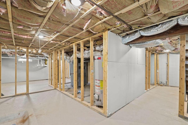 basement featuring heating unit and water heater