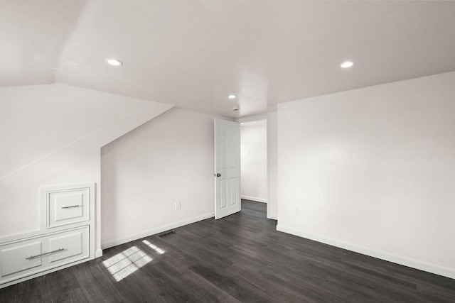 bonus room featuring dark hardwood / wood-style floors and vaulted ceiling