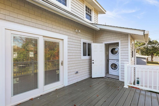 wooden terrace featuring stacked washer / drying machine