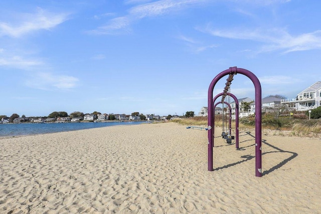 view of home's community with a water view and a view of the beach