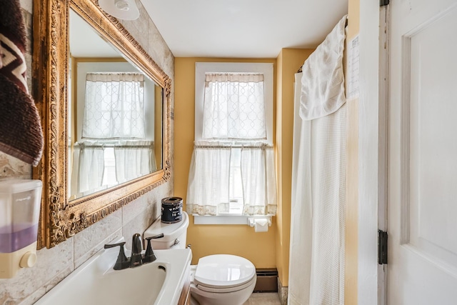 bathroom with baseboard heating, curtained shower, and toilet