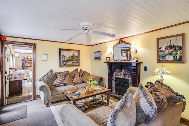 carpeted living room featuring ceiling fan, wooden ceiling, a high end fireplace, and ornamental molding