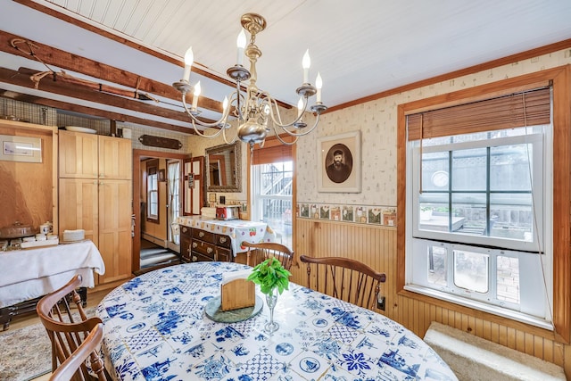 dining area featuring an inviting chandelier and ornamental molding